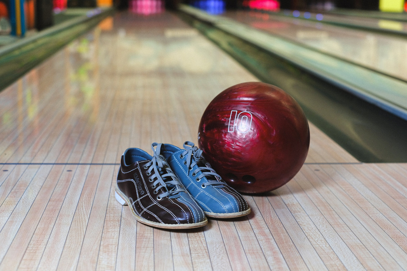 red bowling ball near blue and black shoes