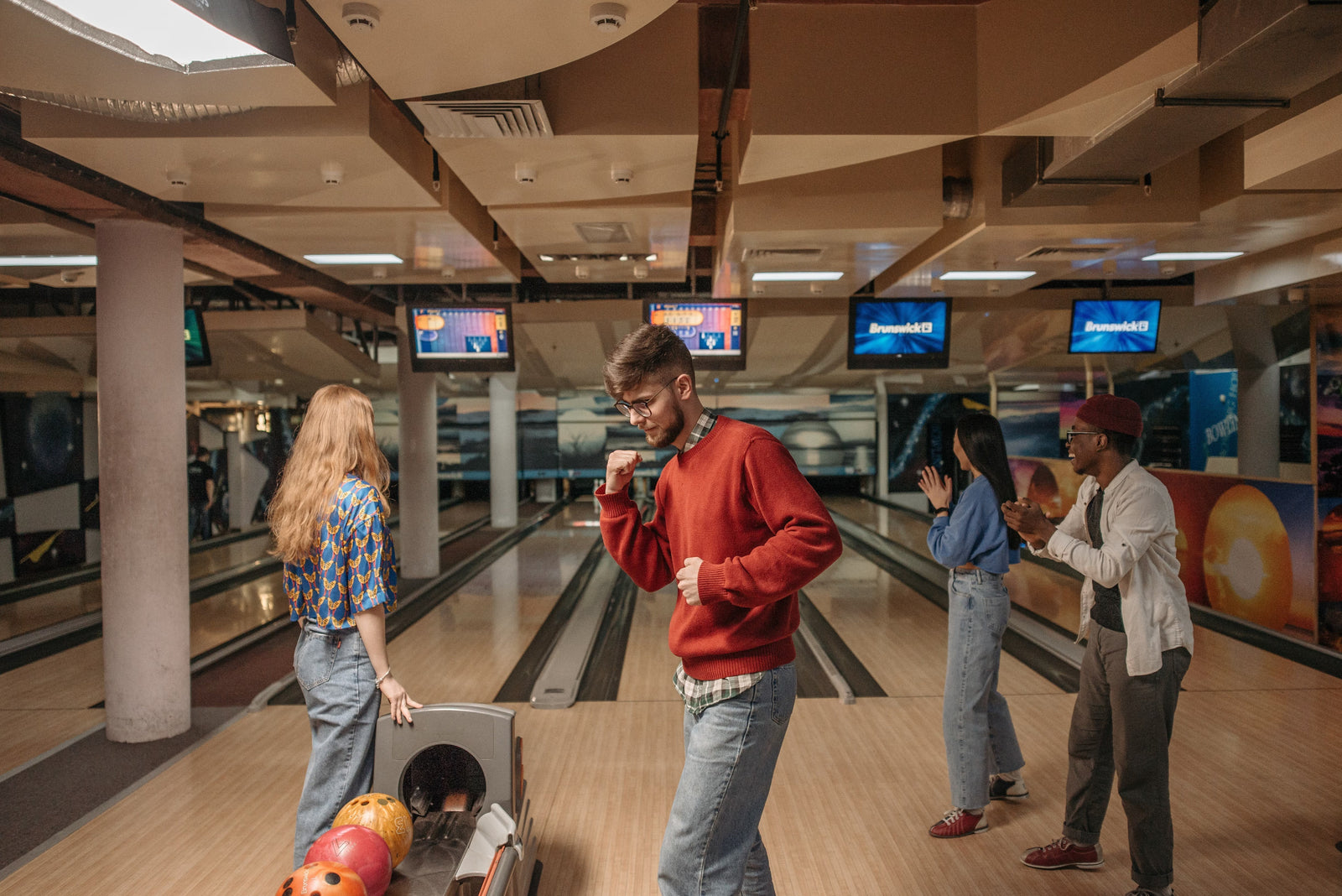 young people bowling in an alley