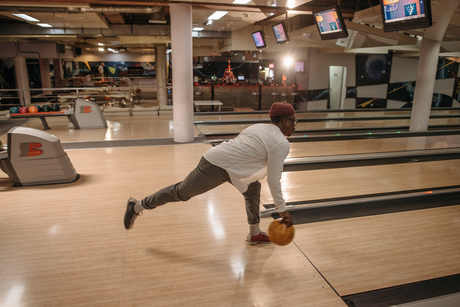 man bowling with orange ball